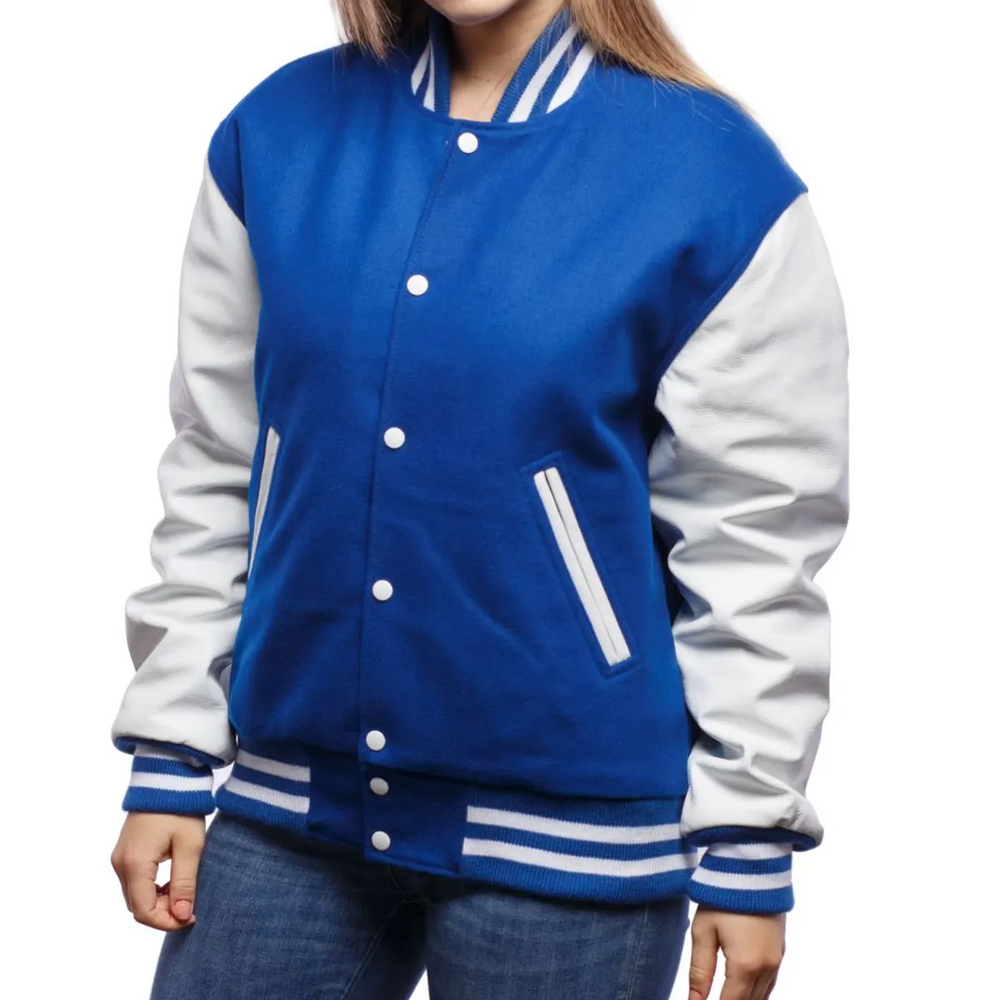 A woman wearing a blue and white varsity jacket with leather sleeves and wool body, buttoned at the front with metal buttons, and white stripes on the cuffs and collar.