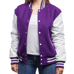 A woman wearing a purple and white varsity jacket with leather sleeves and wool body, buttoned up with metal buttons.