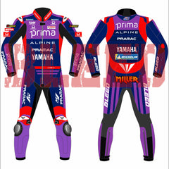 Front and rear views of the Prima Pramac Yamaha MotoGP 2025 racing suit for rider Jack Miller, displaying prominent sponsor logos such as Prima on the chest and back, along with Alpine, Pramac, Yamaha, and the newly added "BLEED" logo on the arms and legs. The suit is primarily blue with red and purple accents. The back of the suit clearly shows the rider name "MILLER"