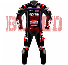 Front view of BLEED-branded Jorge Martin Aprilia 2025 MotoGP suit in red and black with Aprilia Racing, Sterilgarda, and MotoGP sponsor logos. Includes white knee armor, bold 'aprilia' text on sleeves and legs, and detailed chest sponsor panel.