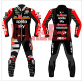 Front and back view of the 2024 Maverick Viñales Aprilia Racing suit design for British GP featuring a black, red, and white color scheme with prominent sponsor logos like Aprilia, Sky, Michelin. The suit showcases detailed graphics on the legs and arms, personalized for Maverick Viñales.