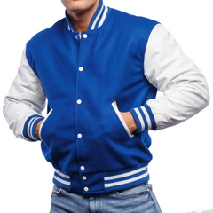 A man wearing a blue and white varsity jacket with leather sleeves and wool body, buttoned up with white stripes on the collar and cuffs.