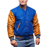 A man wearing a blue and orange varsity jacket with leather sleeves and a collar, buttoned up with metal buttons.