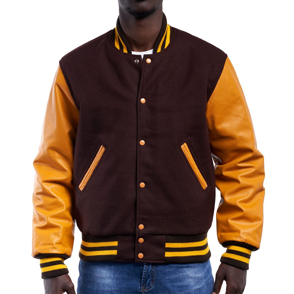 A man wearing a brown and orange varsity jacket with leather sleeves and wool body, buttoned up with metal buttons, and a knitted rib on the collar and cuffs.