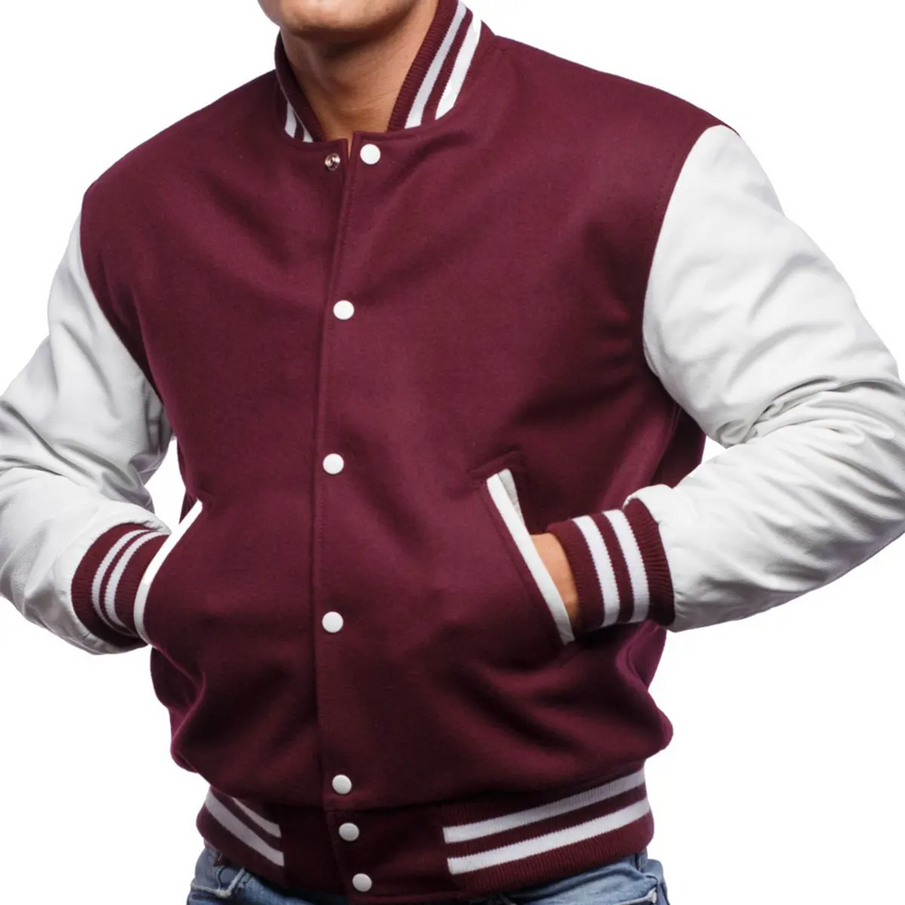 A man wearing a maroon and white varsity jacket with leather sleeves and white button-up front, standing against a white background.