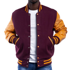 A man wearing a maroon and orange varsity jacket with leather sleeves and wool body, buttoned up with metal buttons.