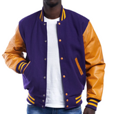 A man wearing a purple and orange varsity jacket with leather sleeves and wool body, buttoned up with metal buttons.