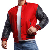 A man wearing a red and black varsity jacket with leather sleeves and a white t-shirt, standing against a white background.