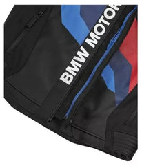 Close-up view of the BMW Motorrad logo on a black leather jacket with blue, white, and red stripes.