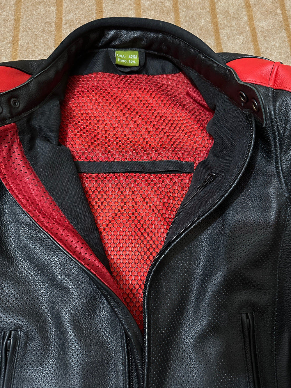 Closeup View of Ducati C4 Leather Motorcycle Jacket – Black and Red Style with Iconic Ducati Logo, High-Quality Perforated Leather, and Sleek Fit for Riders