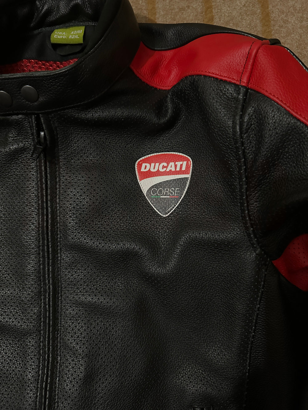 Closeup View of Ducati C4 Leather Motorcycle Jacket – Black and Red Style with Iconic Ducati Logo, High-Quality Perforated Leather, and Sleek Fit for Riders