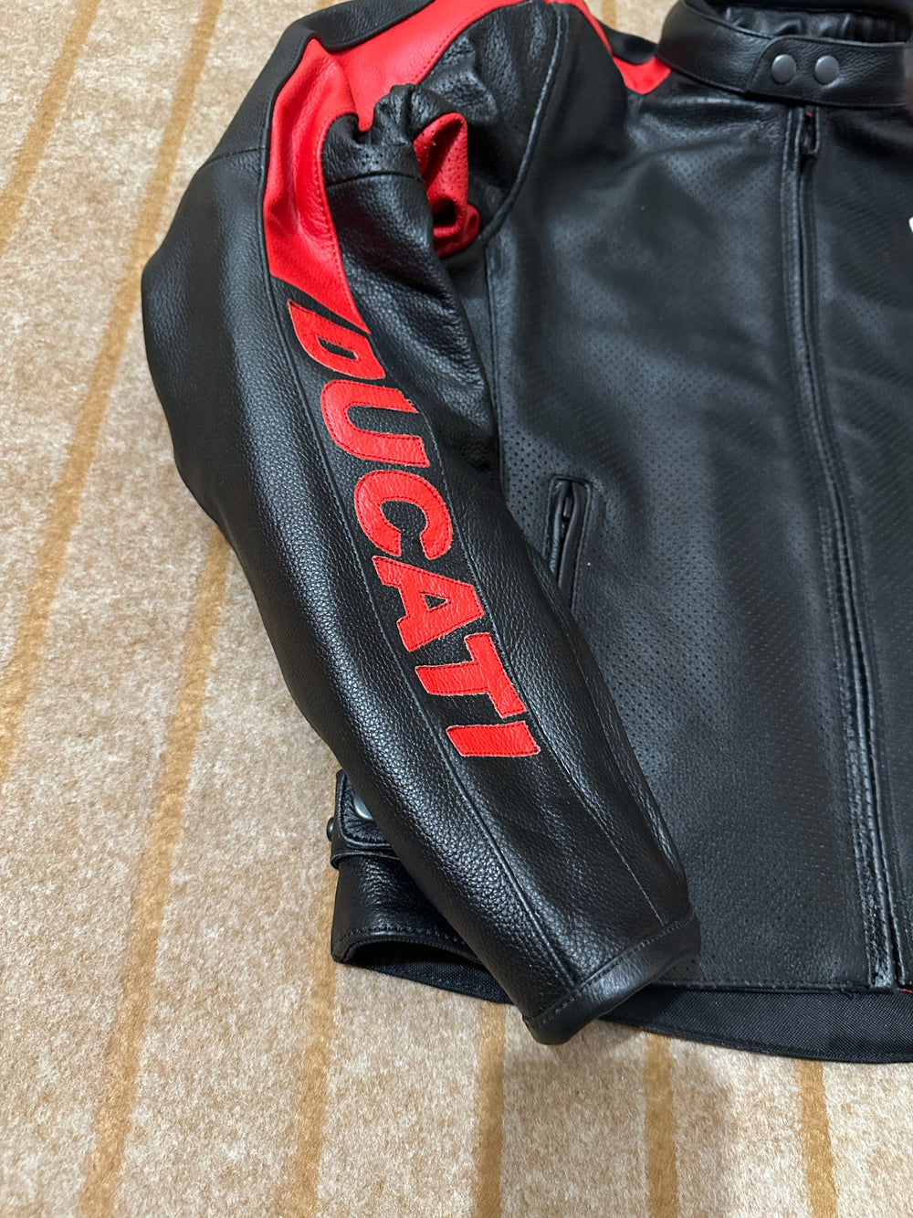 Closeup View of Ducati C4 Leather Motorcycle Jacket – Black and Red Style with Iconic Ducati Logo, High-Quality Perforated Leather, and Sleek Fit for Riders