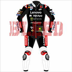 Francesco Bagnaia Ducati Motorcycle Riding Suit BritishGP 2024. The suit is predominantly black with red and white accents, featuring sponsor logos such as Lenovo, Monster, and NetApp. The design includes matching gloves and boots, emphasizing a professional and cohesive look for motorsport racing.