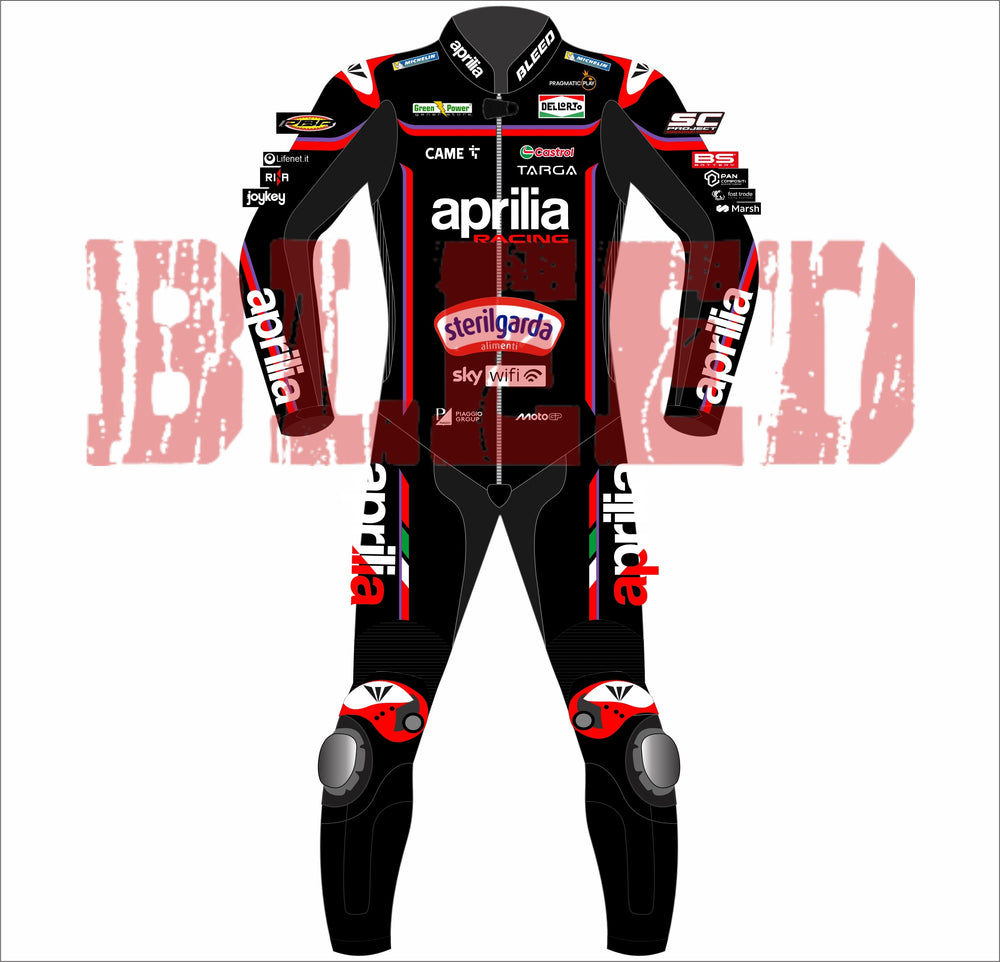 Front view of BLEED-branded Jorge Martin Aprilia 2025 MotoGP suit in red and black with Aprilia Racing, Sterilgarda, and MotoGP sponsor logos. Includes white knee armor, bold 'aprilia' text on sleeves and legs, and detailed chest sponsor panel.