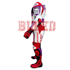 Left side view of the 2023 Ducati Pramac MotoGP Racing Leather Suit worn by Jorge Martin. The suit showcases sponsor logos like Pramac, Akrapovic, and Wallife, along with protective padding on the elbows and knees. Red boots and gloves complement the purple, red, and white color scheme, designed for high-performance motorcycling