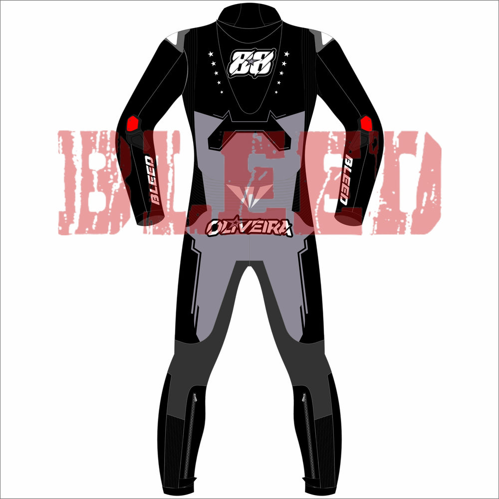 Back view of Miguel Oliveira’s Bleed 2025 MotoGP test suit, showcasing clean black and grey contrast, “88” logo with stars on the upper back, Oliveira name graphic at the waist, and red elbow patch highlights with Bleed branding.