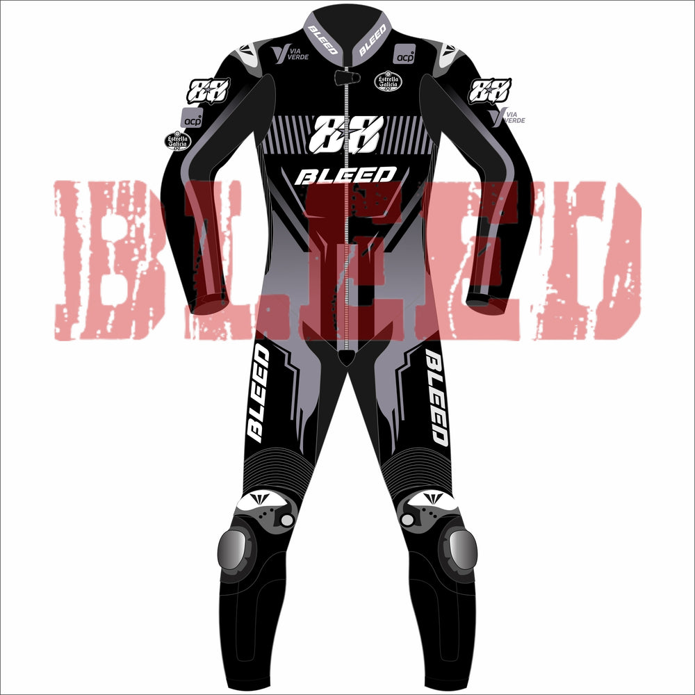 Front view of Miguel Oliveira’s custom MotoGP 2025 test race suit in black and grey, with bold “88” number on the chest, Bleed branding on chest, arms, and thighs, and detailed graphics along the knees and legs for aggressive styling.