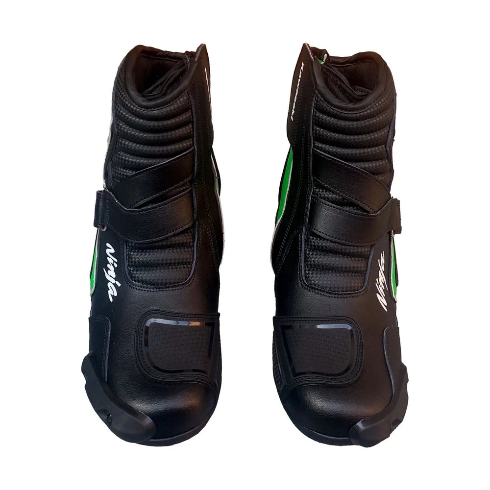 Pair of black and lime green Kawasaki Ninja professional leather motorcycle racing boots featuring toe sliders, ankle protection, and reinforced gear shift pads.