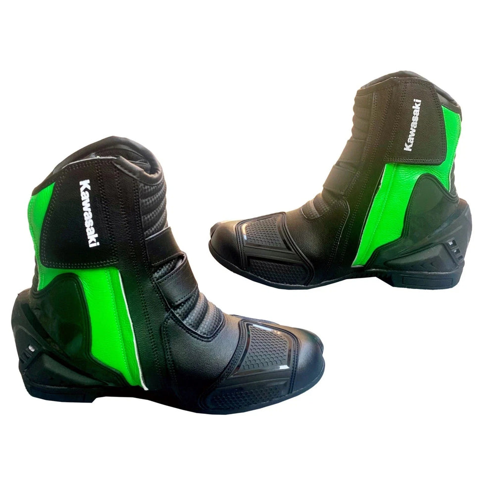 Pair of black and lime green Kawasaki Ninja professional leather motorcycle racing boots featuring toe sliders, ankle protection, and reinforced gear shift pads.