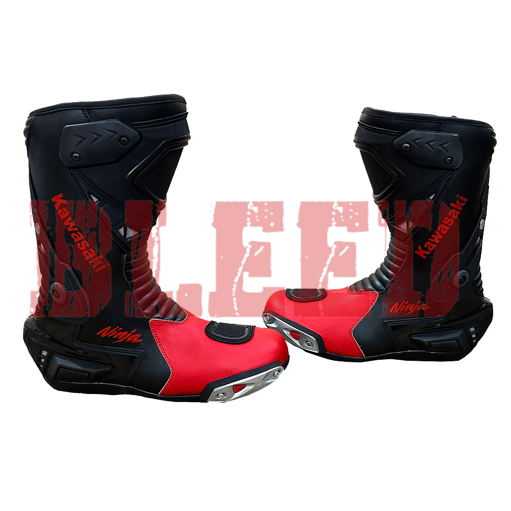 Front angle view of Kawasaki Ninja red and black motorbike leather boots showing TPU shin armor, steel toe sliders, and aggressive racing design.