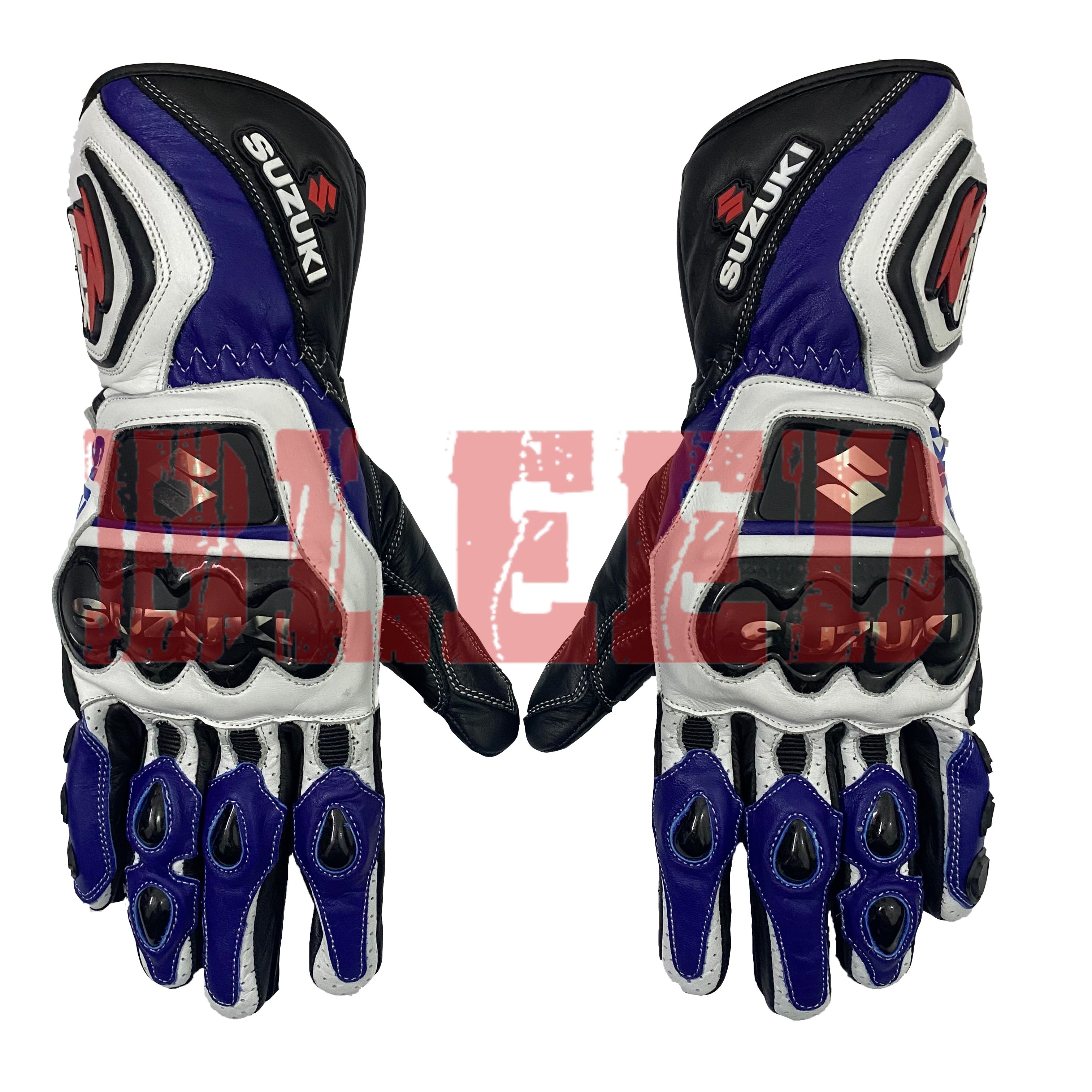 A pair of Suzuki motorcycle racing gloves in blue, white, and black colors. The gloves feature protective knuckle guards with the Suzuki logo, reinforced palms, and finger protection. They have a sporty design with a mix of leather and synthetic materials, Suzuki branding on the wrist strap, and the Suzuki "S" logo on the side. The gloves appear to be designed for high-performance riding and safety