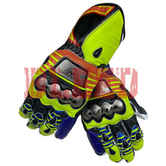 A pair of Valentino Rossi 2016 MotoGP racing gloves, showcasing a dynamic design with vibrant yellow, blue, red, and black colors. These gloves feature reinforced knuckles with prominent metallic plates, offering both safety and the distinctive style of Rossi's 2016 MotoGP gear